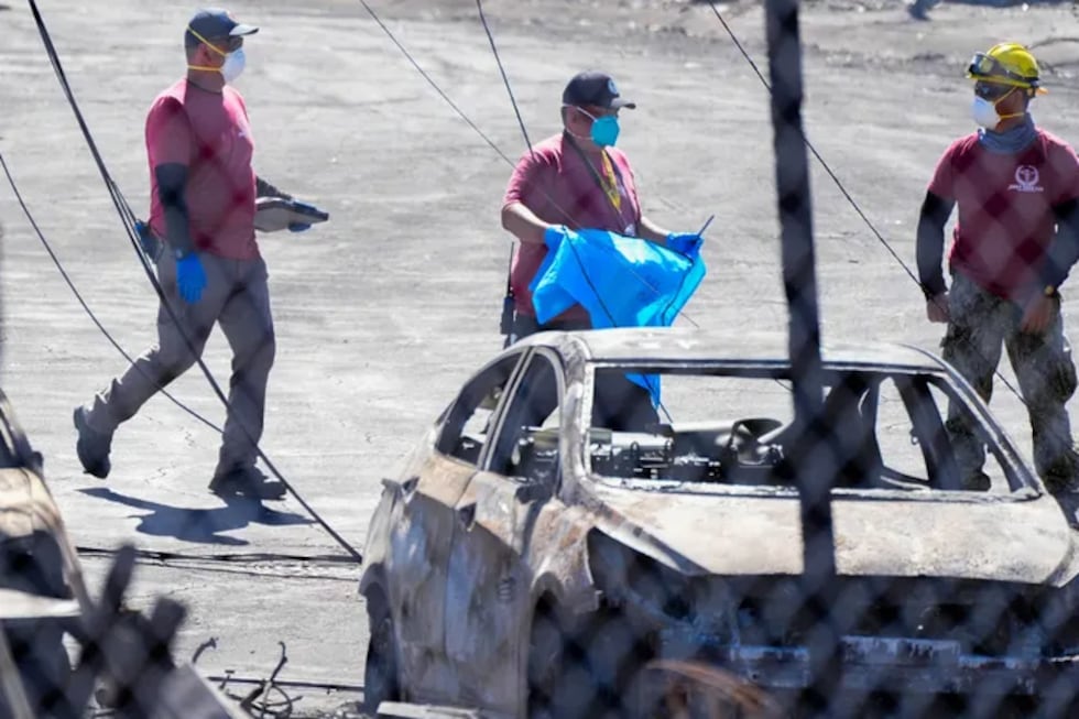 This photo shows Grey Tech employee Christopher Napoleon, middle, in Lahaina after the fire.