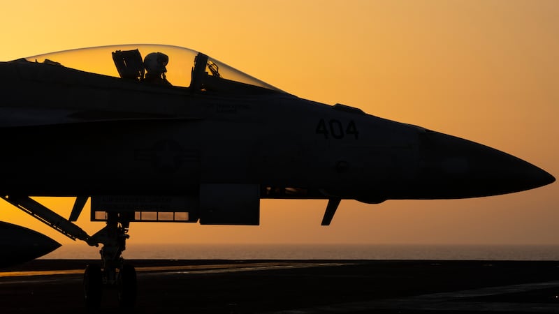 FILE - A fighter jet maneuvers on the deck of the USS Dwight D. Eisenhower in the Red Sea,...