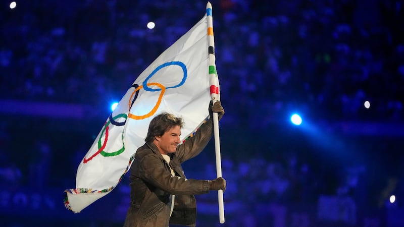 Tom Cruise carries the Olympic flag during the 2024 Summer Olympics closing ceremony at the...