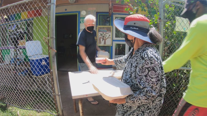 Wally Inglis hands out hot lunches to folks at St. Elizabeth's Episcopal Church on Tuesday.