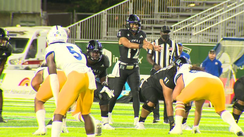 UH junior quarterback Chevan Cordeiro approaches the line