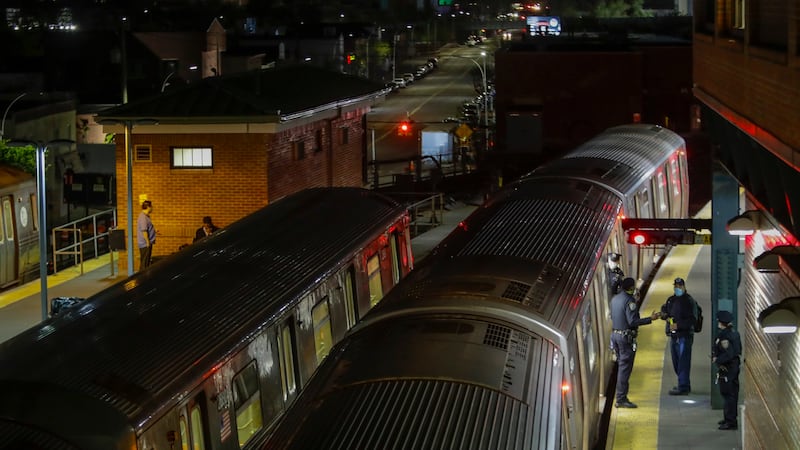 FILE - New York Police officers clear a train at the Coney Island Stillwell Avenue Terminal,...