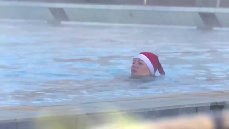 Not sure those hats will help; swimmers in Germany brave sub-zero temps during special event.