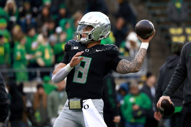 Oregon quarterback Dillon Gabriel warms up before an NCAA college football game against...