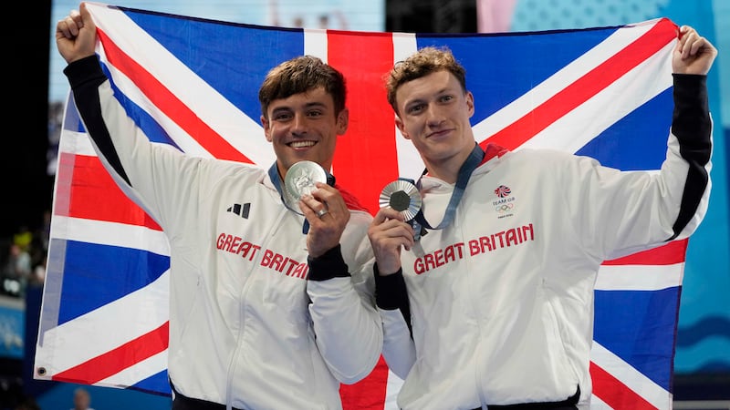 Britain's Thomas Daley, left, and Noah Williams celebrate on the podium after winning the...